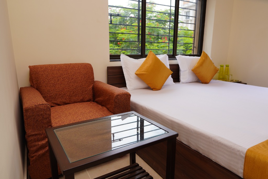 Comfortable guest room with armchair and coffee table