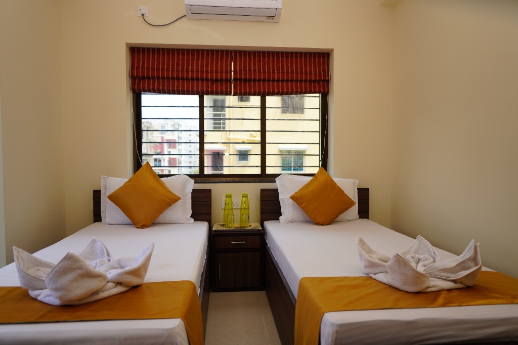 Comfortable guest bedroom with twin beds and towel art