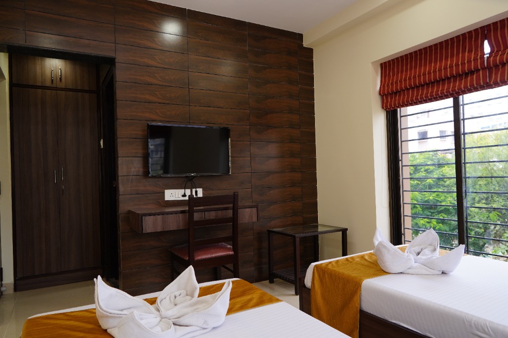 Guest bedroom with twin beds and TV setup