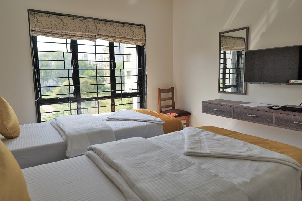Comfortable guest bedroom with twin beds and amenities